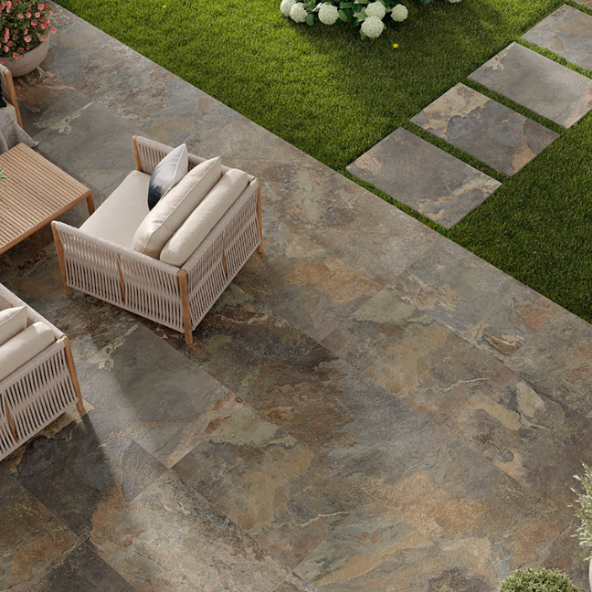 Natural stone effect 2cm outdoor porcelain paving slabs in 60x90cm, creating a stylish patio with outdoor seating and garden stepping stones.