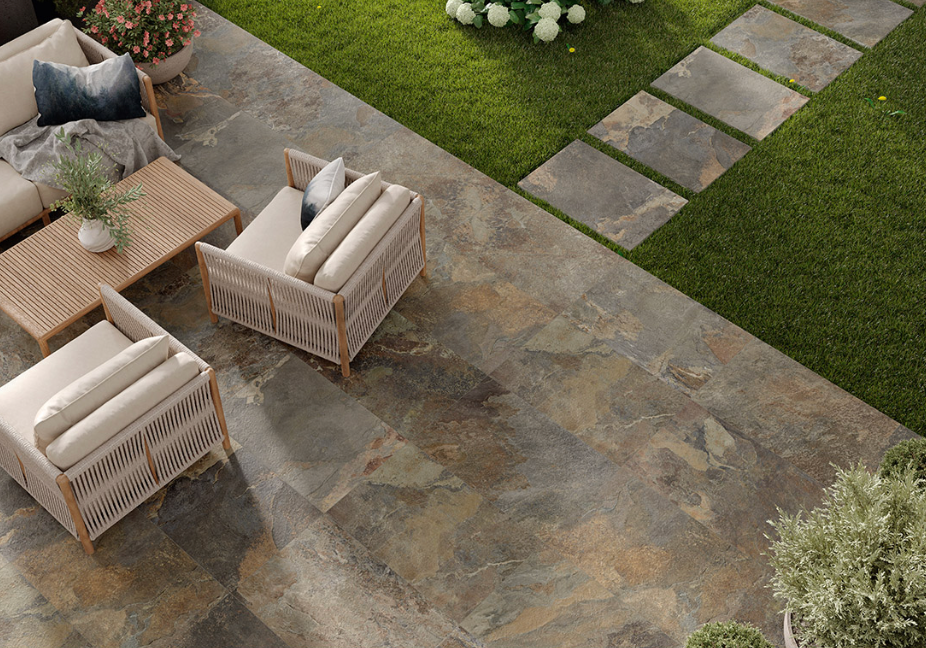 Natural stone effect 2cm outdoor porcelain paving slabs in 60x90cm, creating a stylish patio with outdoor seating and garden stepping stones.