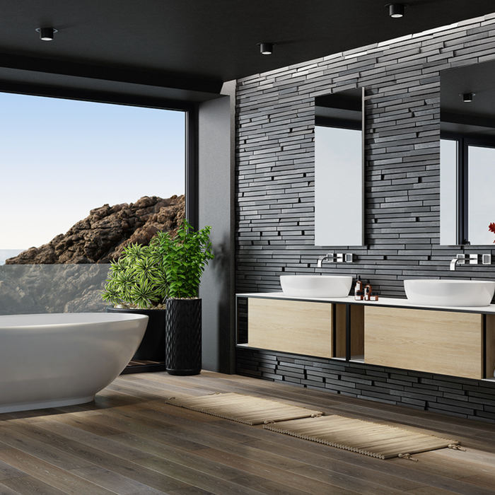 Modern luxury bathroom with stone effect wall tiles, freestanding bath and double vanity unit