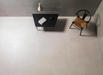 Porcelanosa Bottega Topo L 120x120cm shown in a styled room setting