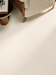 Porcelanosa Cancun Caliza L 120x120cm shown in a styled room setting