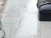 Porcelanosa Carrara Blanco Natural L 59.6x59.6cm shown in a styled room setting