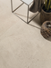 Porcelanosa Durango Bone Ant.l 120x120cm shown in a styled room setting