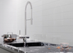 Porcelanosa Kent Snow Gloss 8x30x0.85 8x30cm shown in a styled room setting
