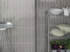Porcelanosa Malaga Acero L 25x44.3cm shown in a styled room setting