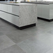 Porcelanosa Meaux Acero L 60.2x60.2cm shown in a styled room setting